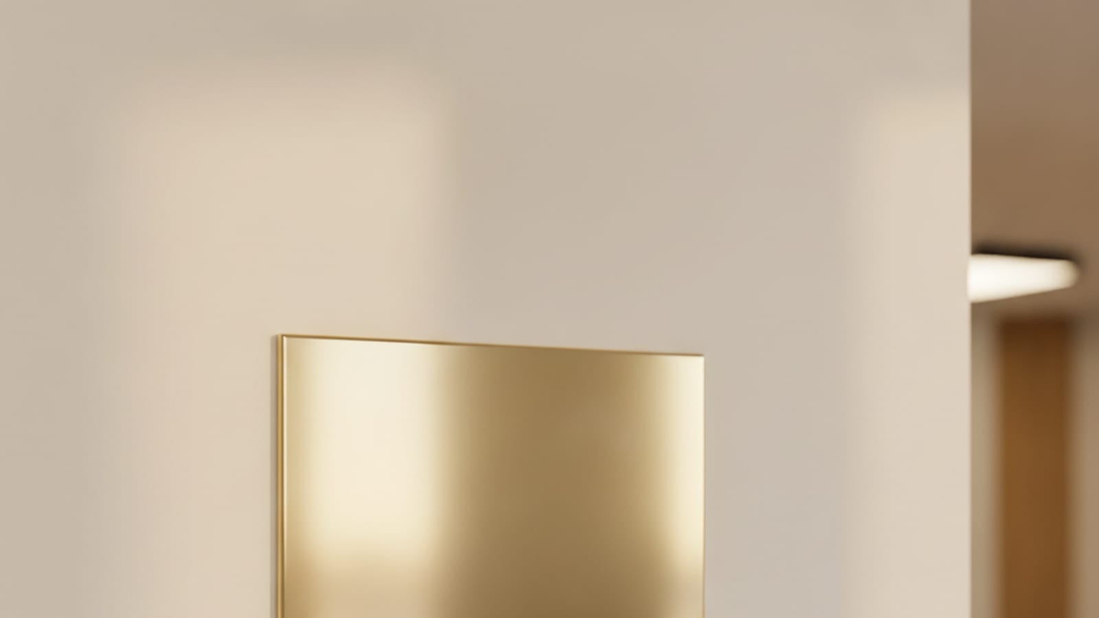 A blank polished brass plaque on a clean wall