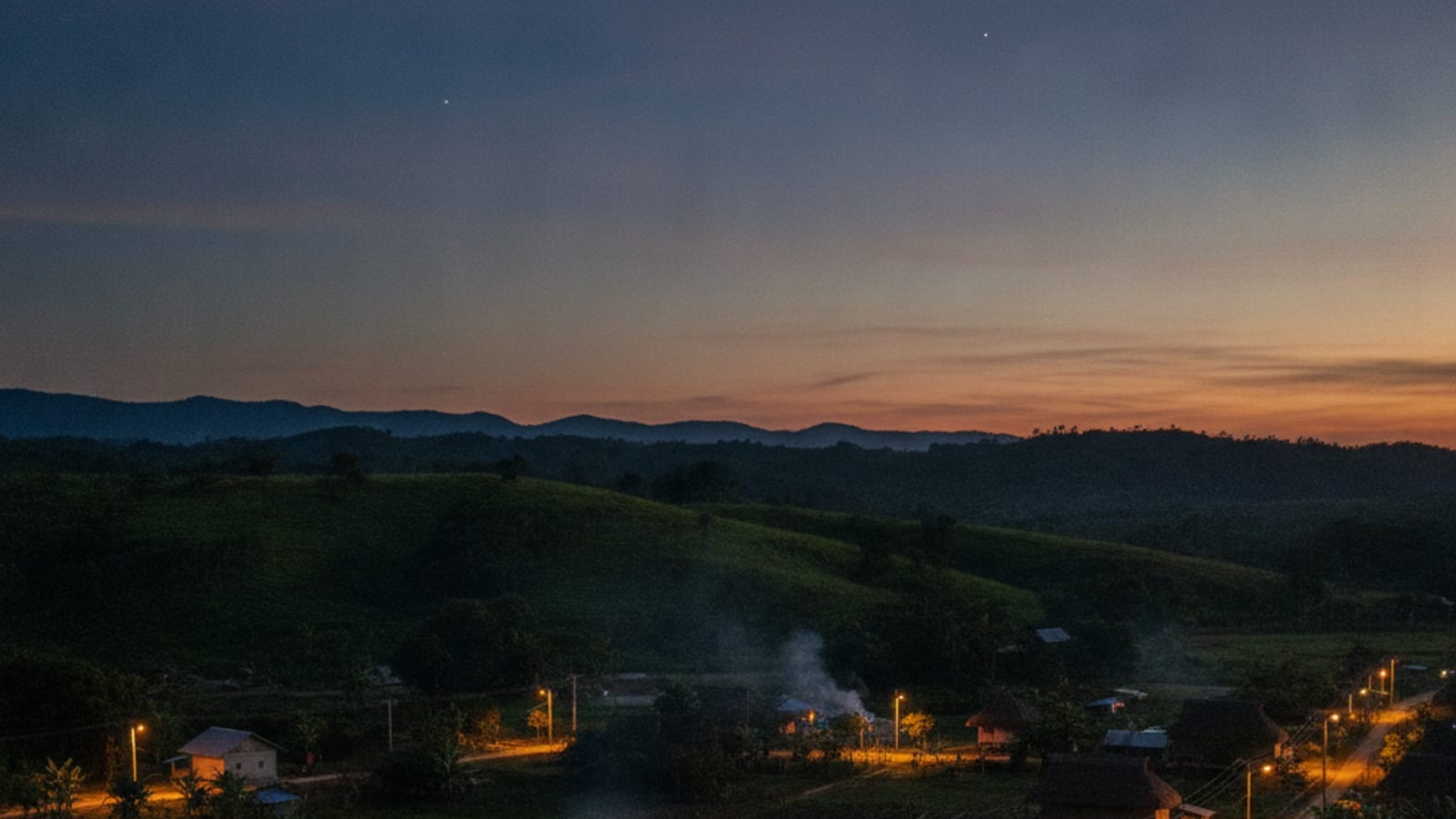 Rural Timor-Leste village illuminated by new electricity, symbolizing development.