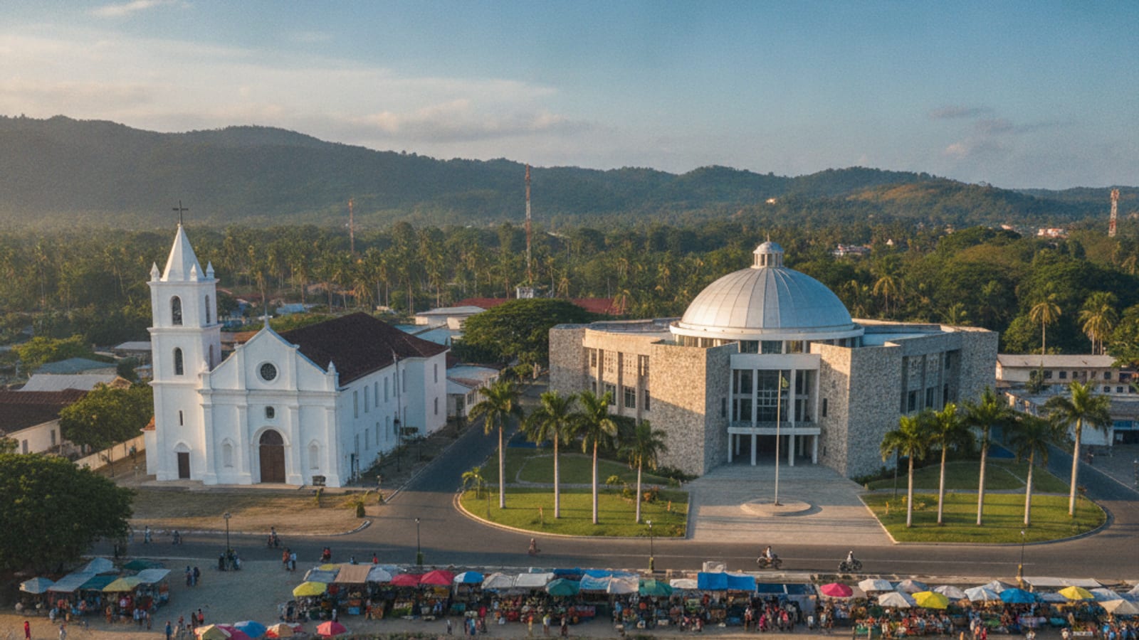 View of Dili city with a prominent church steeple and modern buildings, reflecting the blend of culture and development.