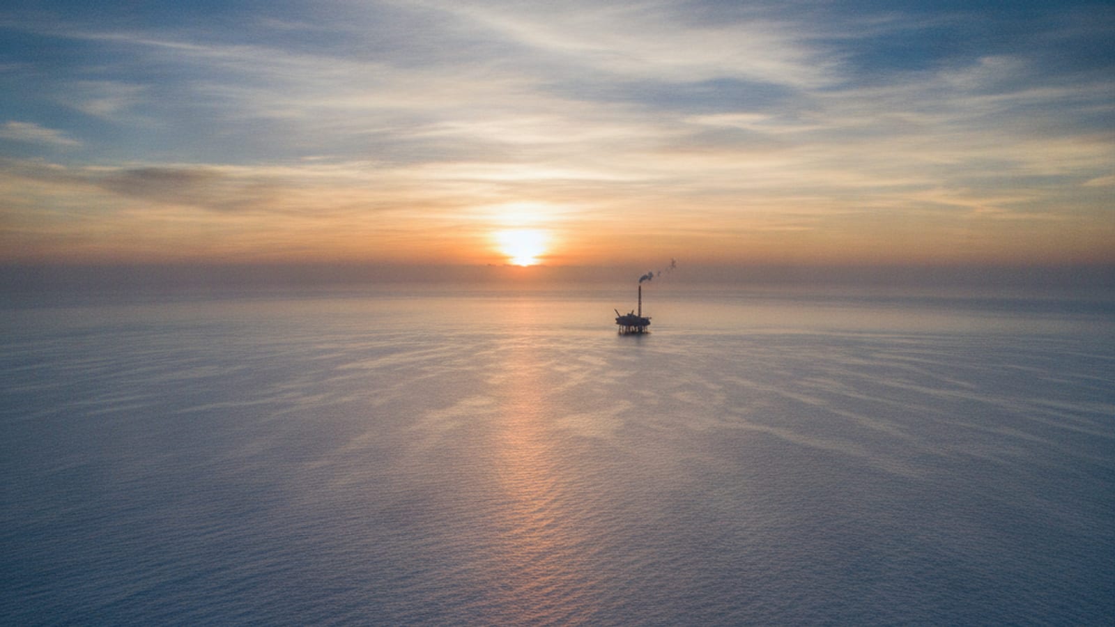 Aerial view of the Timor Sea at sunrise with an offshore energy platform, symbolising Timor-Leste's natural gas potential.