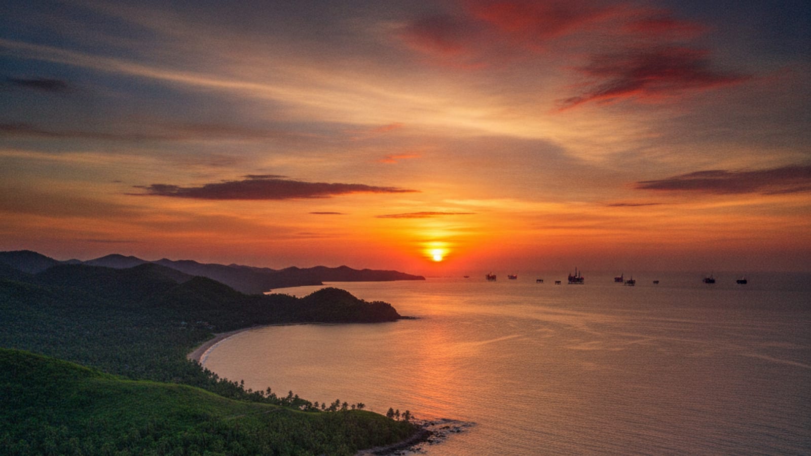 Sunset over the Timor-Leste coastline with a distant view of offshore energy platforms, symbolizing the nation's energy future.